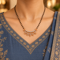 Anvaya Mangalsutra worn with a slate-blue Indian kurta, showing five open marquise motifs