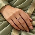 Celeste rose gold plated ring worn on a model's hand with a sage silk saree