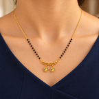 Kanakpriya twin-heart mangalsutra worn with a professional navy dress in a close neckline view