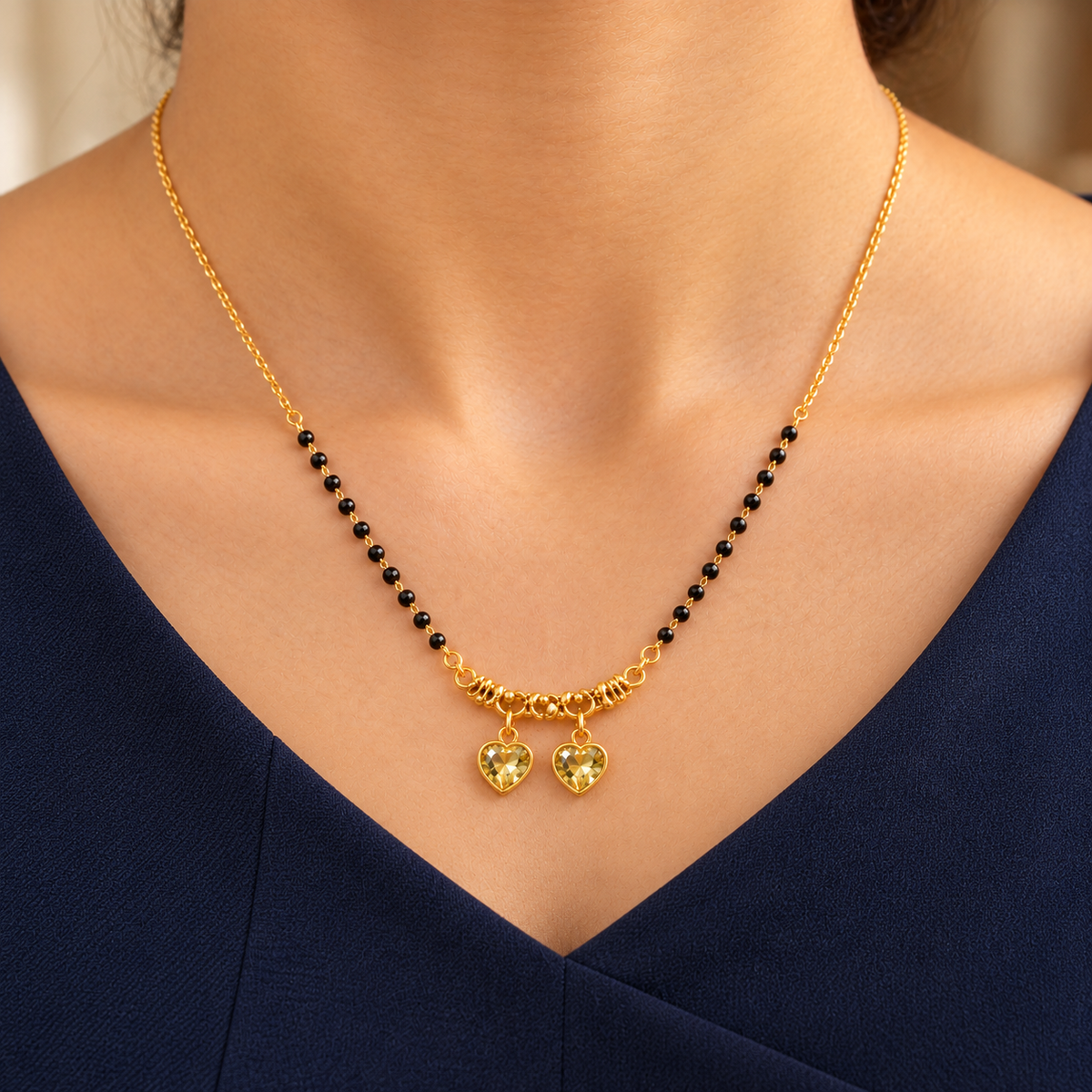 Kanakpriya twin-heart mangalsutra worn with a professional navy dress in a close neckline view