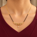 Madhavi floral mangalsutra worn with a professional burgundy dress in a close neckline view
