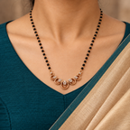 Neerja Mangalsutra worn with a teal blouse and champagne saree, close-up