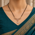 Saanvika Mangalsutra with seven clear round accents and a pear drop worn with a teal Indian saree