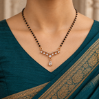 Saanvika Mangalsutra with seven clear round accents and a pear drop worn with a teal Indian saree
