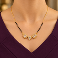 Triveni Mangalsutra worn with a modest plum V-neck dress in a close-up