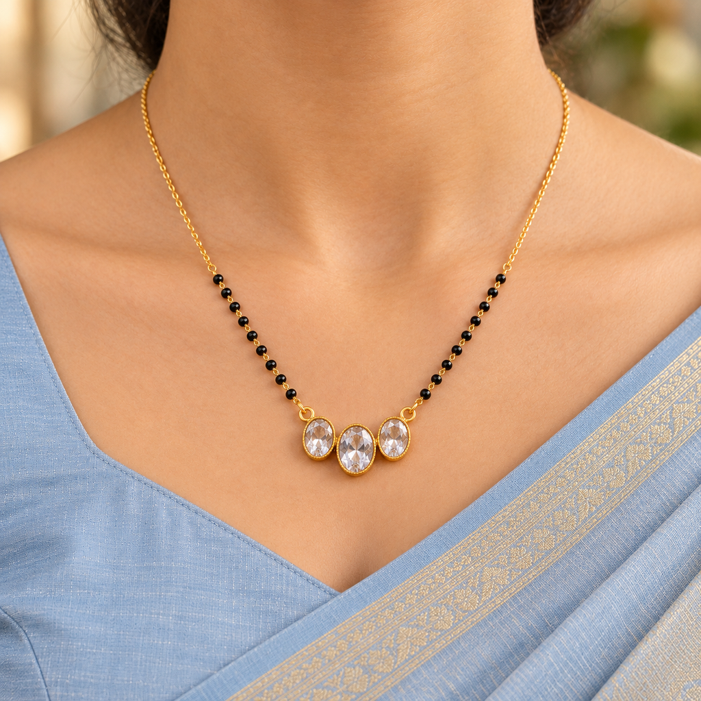 Vaidehi Mangalsutra with three oval accents, worn with a powder-blue silk saree in a close-up