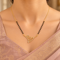 Varnika openwork mangalsutra worn with an elegant rose-beige silk saree in a close neckline view