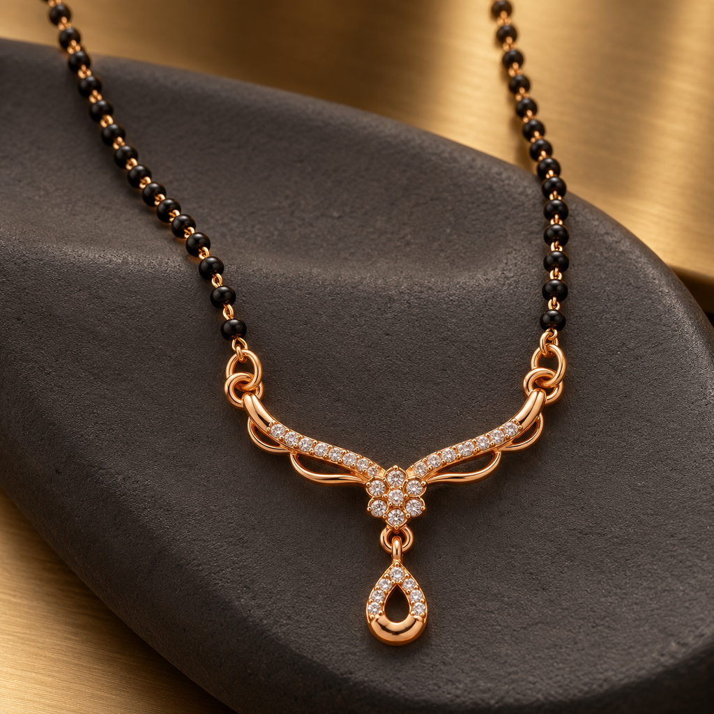 Angled view of Aarohi Mangalsutra on charcoal ceramic with a warm metallic background