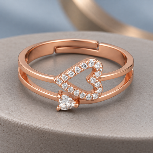 Adeline rose gold plated double-band ring with sideways open heart and small lower accent on a ceramic pedestal
