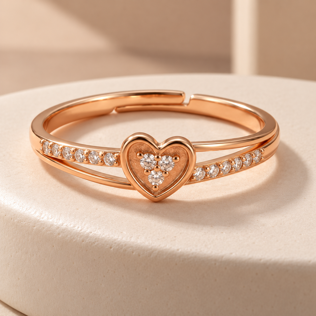 Amorette rose gold plated heart ring on an ivory ceramic plinth, showing its clear cluster and open layered band