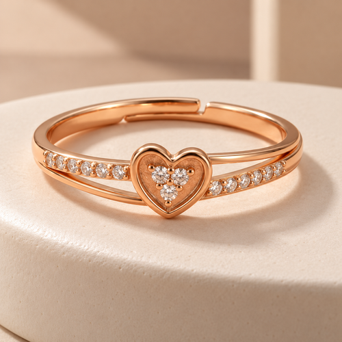 Amorette rose gold plated heart ring on an ivory ceramic plinth, showing its clear cluster and open layered band