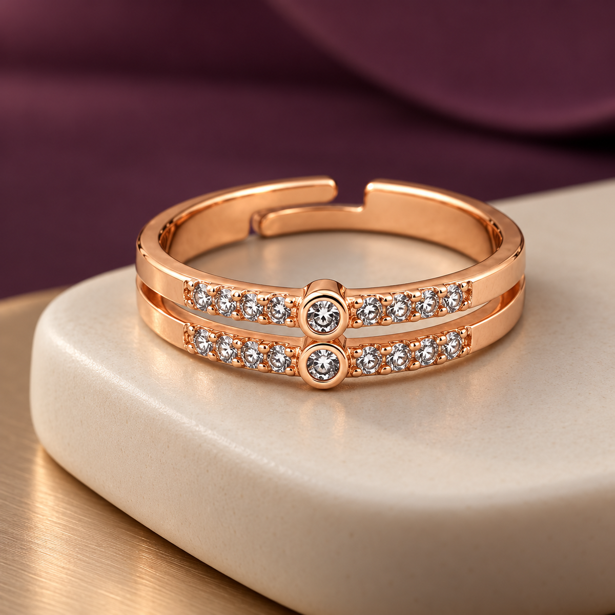 Celeste adjustable ring with two round centre settings on a ceramic plinth