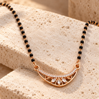 Chandralekha Mangalsutra at an oblique angle on ivory travertine