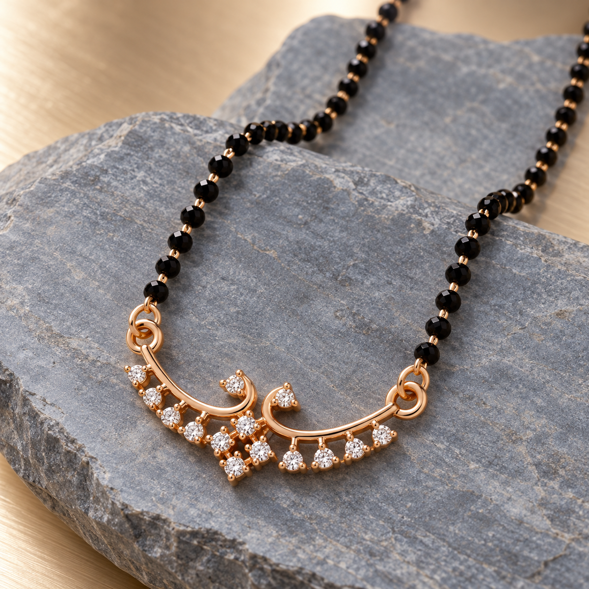 Hansika Mangalsutra paired gold scrolls and clear fringe on blue-grey stone