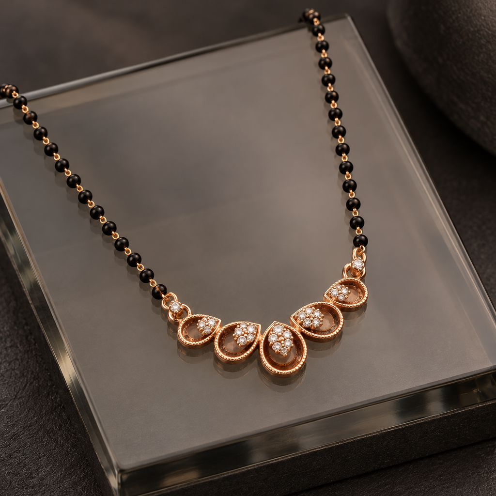 Neerja Mangalsutra five teardrop motifs photographed at an angle on smoked glass