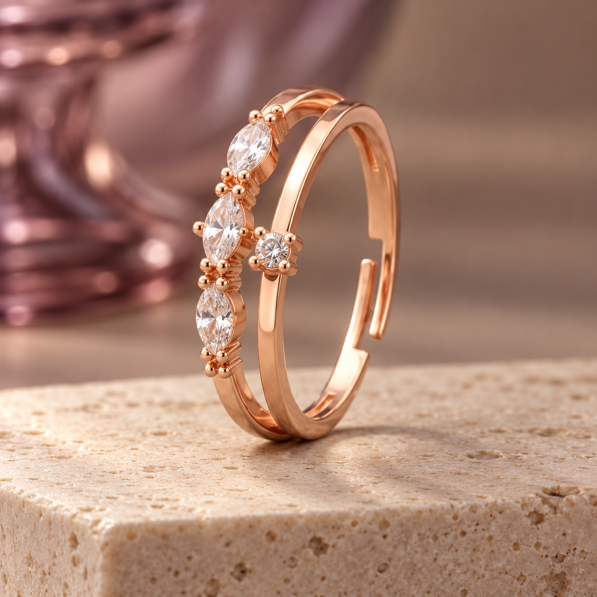 Roselle adjustable ring with three marquise accents and a central round setting on travertine