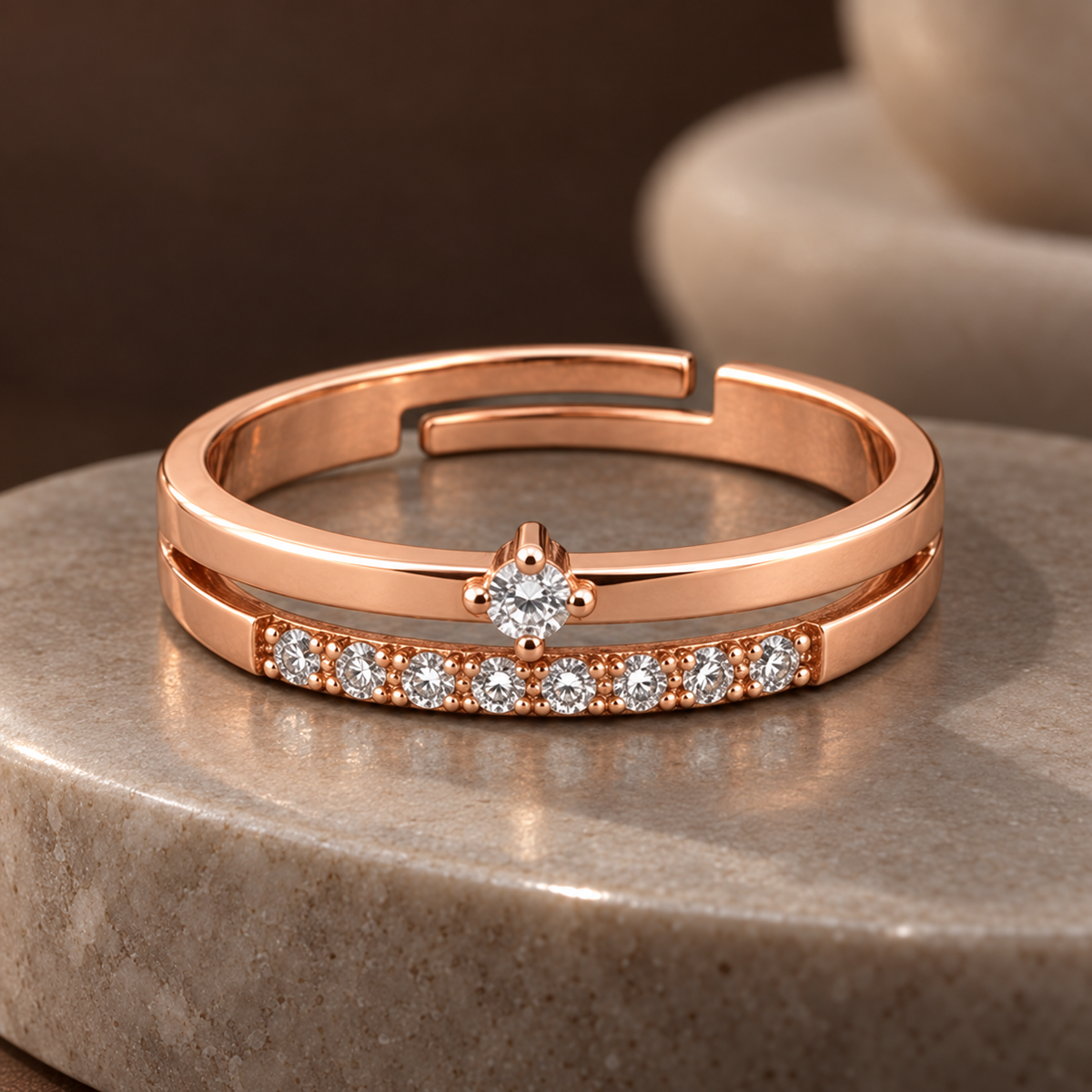 Serenity rose gold plated double-band ring with a centred round setting and eight lower accents on polished stone
