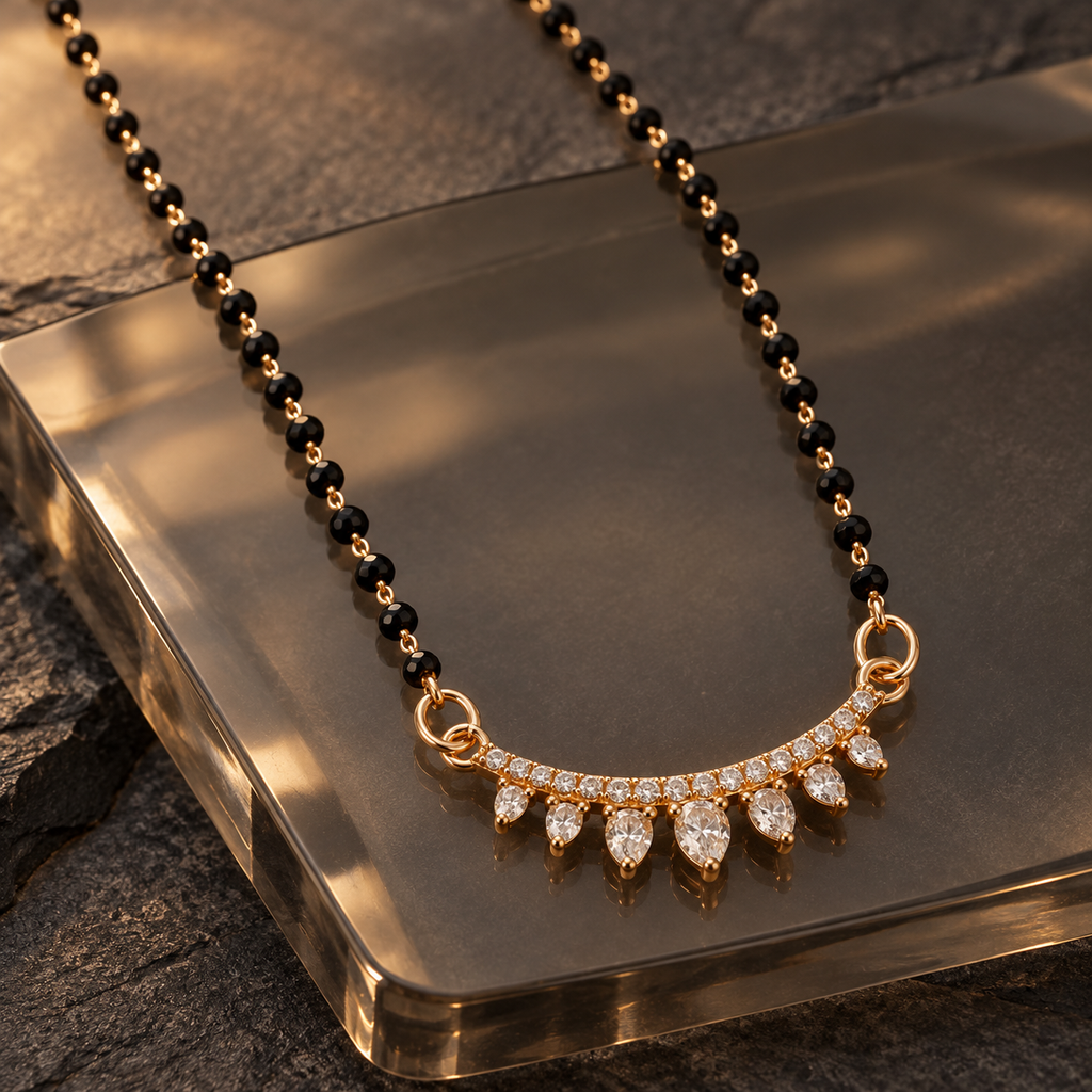 Sitara Mangalsutra seven graduated clear teardrops photographed at an angle on smoky glass