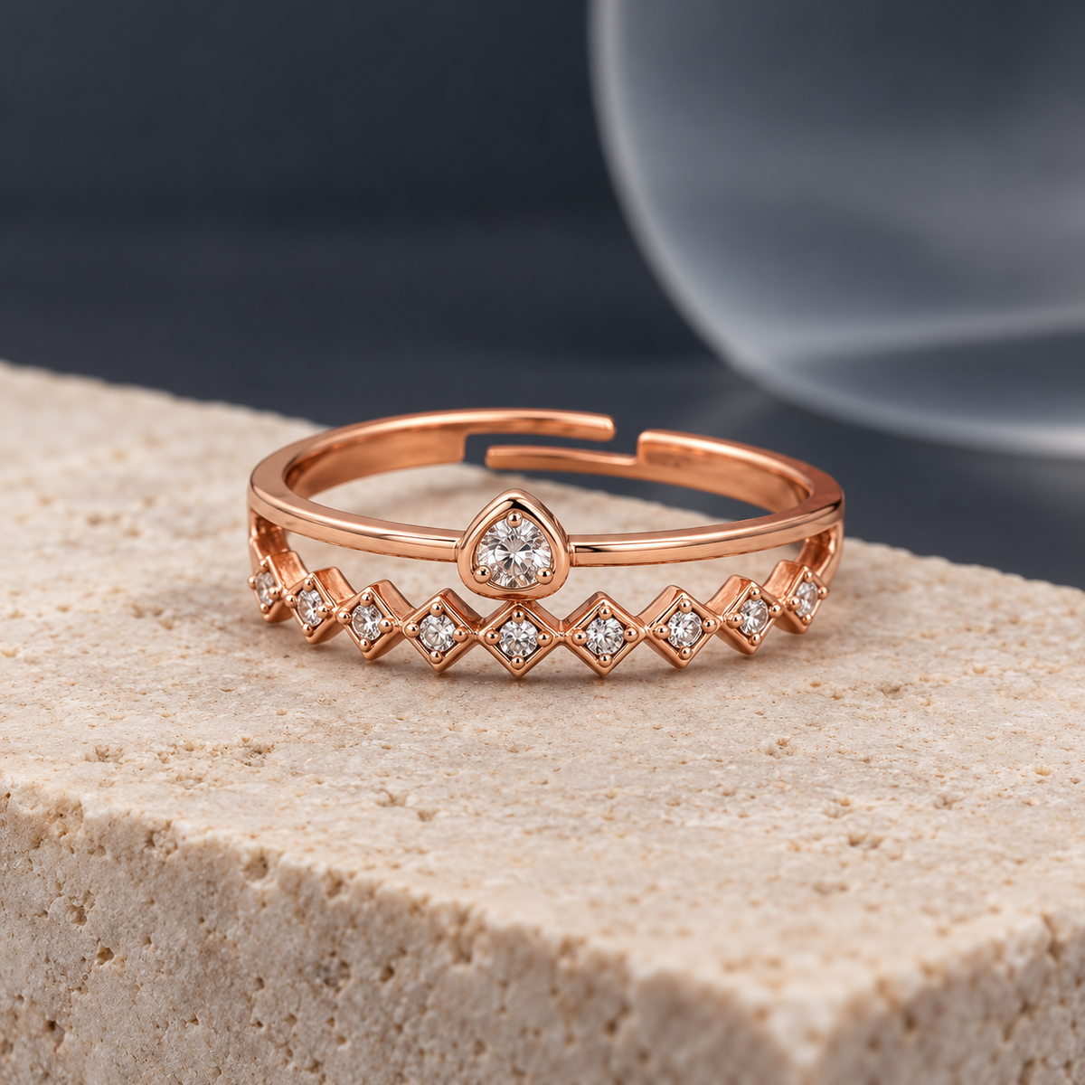 Solstice ring with upright teardrop-shaped centre and geometric band on limestone