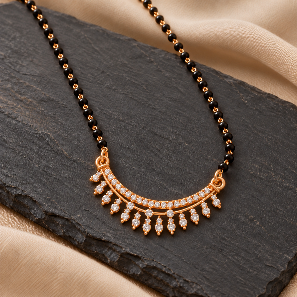 Angled view of Tarunika Mangalsutra on charcoal slate with a muted sand textile