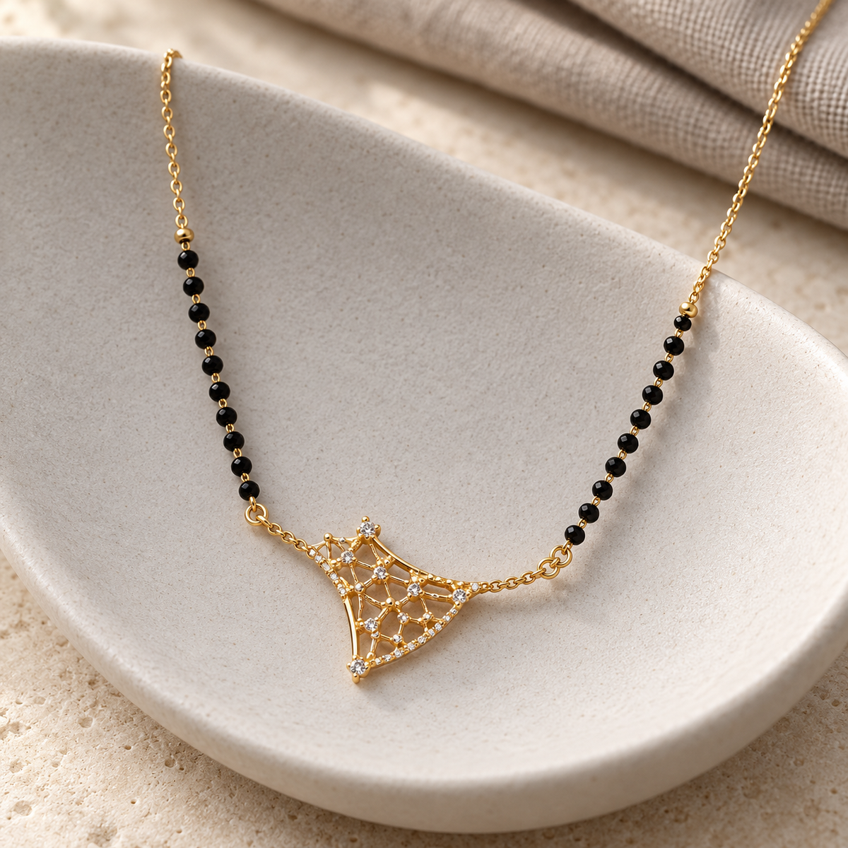 Varnika angular openwork mangalsutra on sculpted porcelain, photographed at an angle