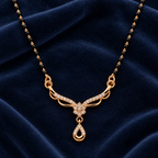 Close detail of Aarohi Mangalsutra floral openwork pendant and black-bead chain on navy velvet