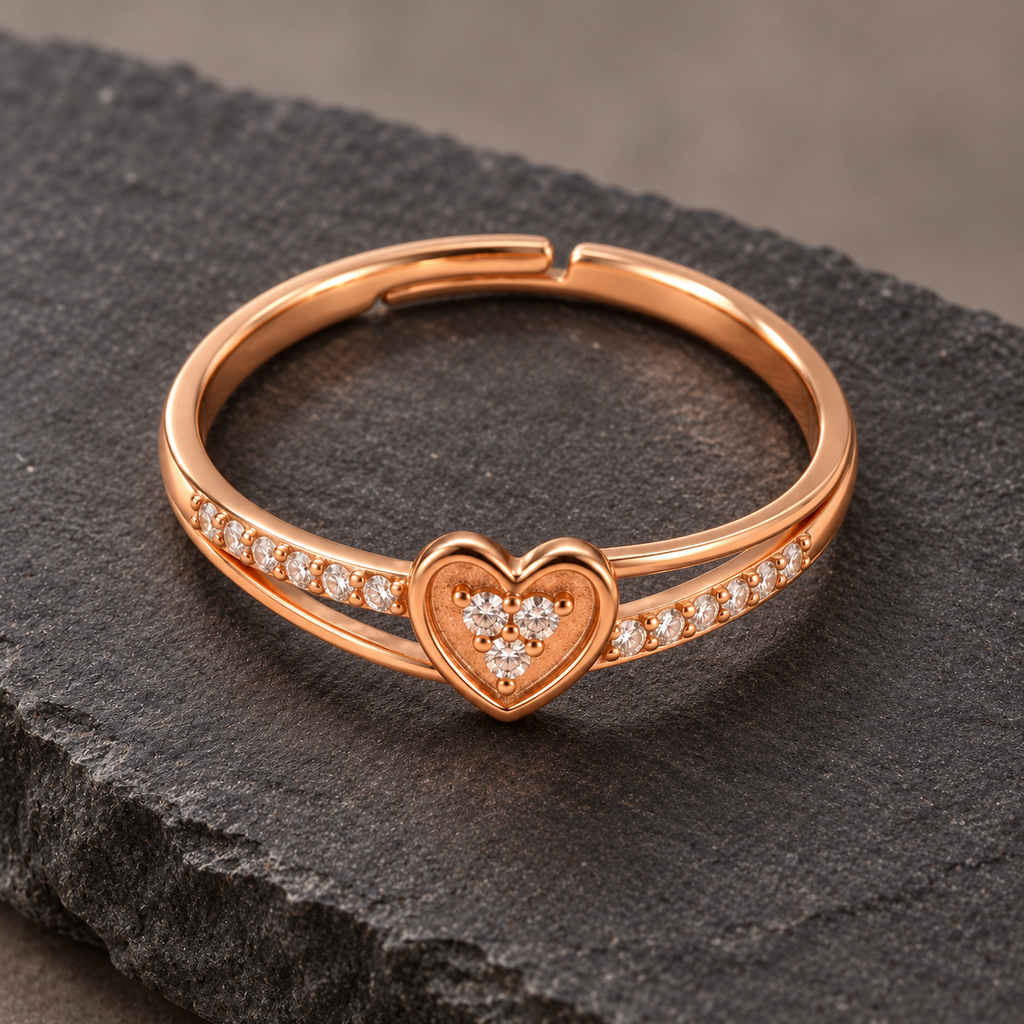 Amorette heart ring from a high angle on dark stone, showing the clear cluster, open band and adjustable back