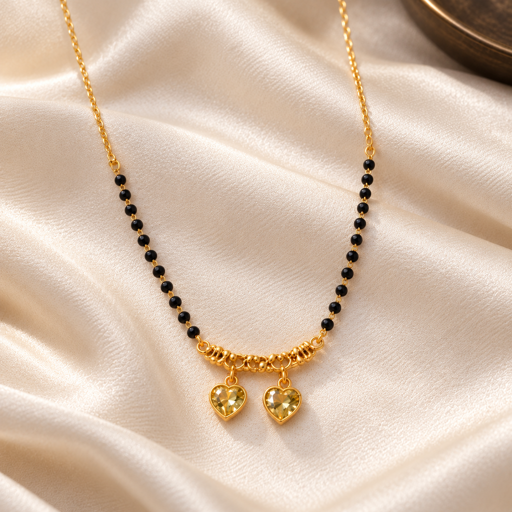 Overhead detail of Kanakpriya twin-heart mangalsutra on ivory silk