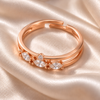 Roselle ring on ivory satin with the small round setting centred above the middle marquise accent