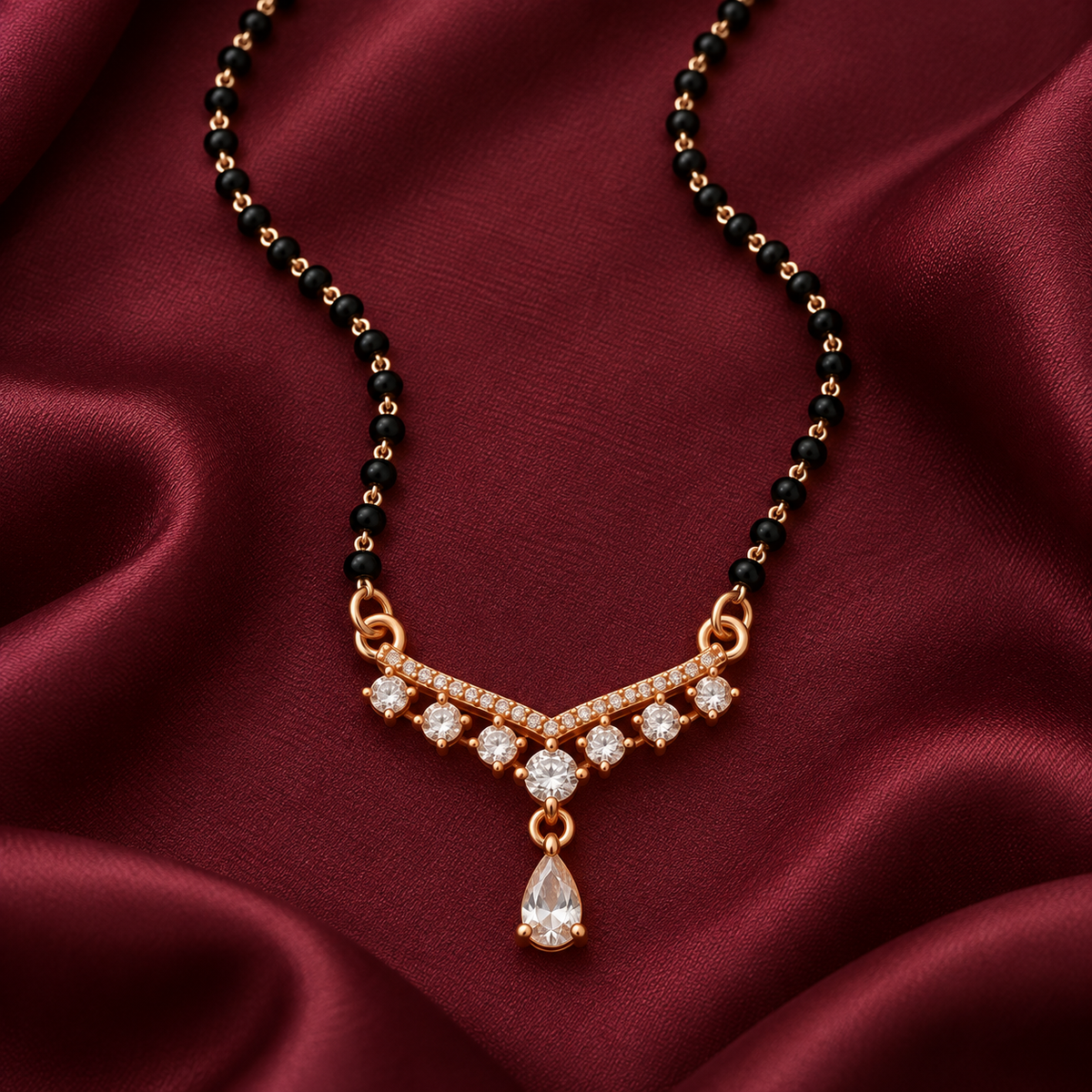 Overhead detail of Saanvika Mangalsutra seven clear round settings, pear drop and black beads on wine silk