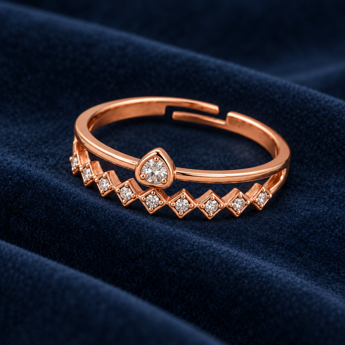 Solstice ring geometric setting and open band detail on deep blue velvet