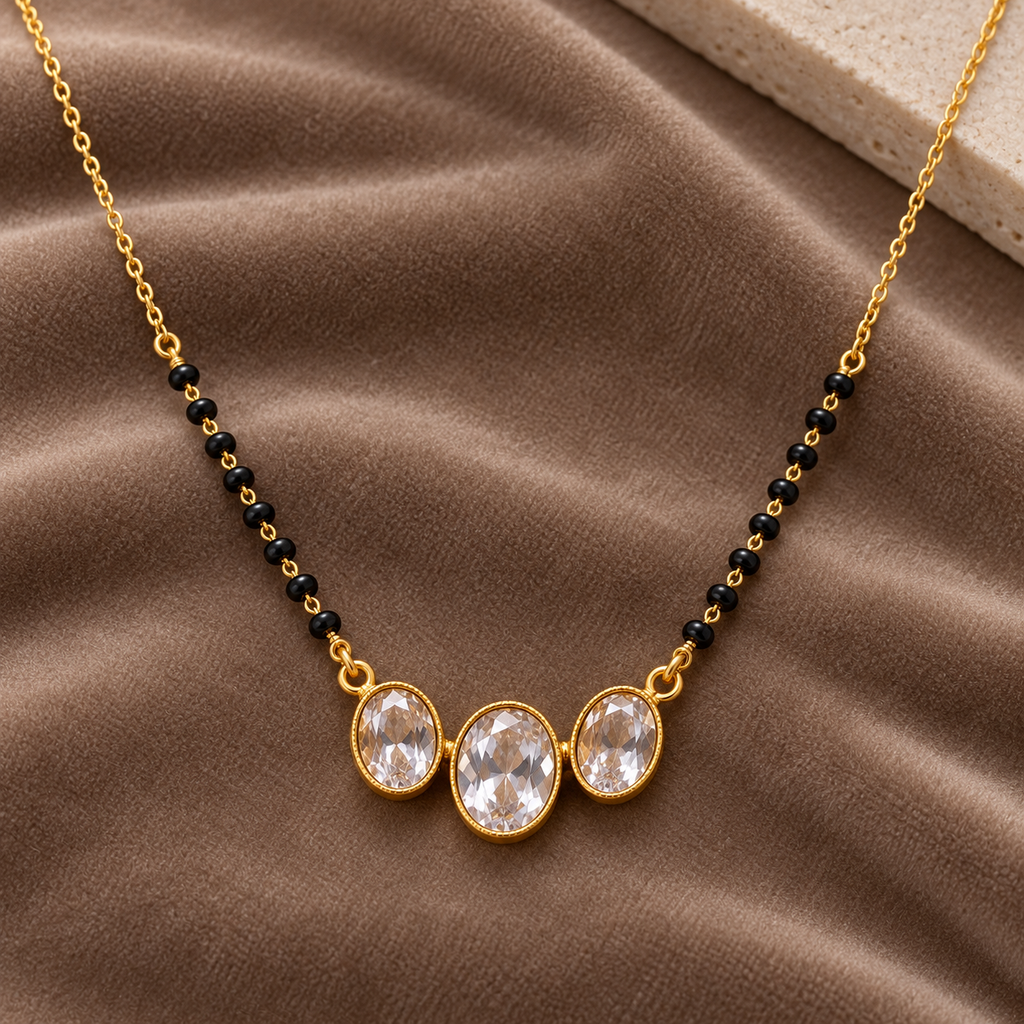 Overhead detail of Vaidehi Mangalsutra three oval centres on deep taupe velvet