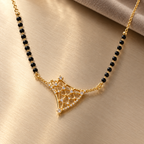 Overhead detail of Varnika openwork mangalsutra on brushed champagne metal