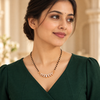 Sitara Mangalsutra styled with an elegant forest-green professional dress in a model portrait