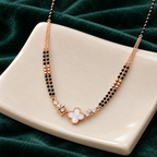 White clover mangalsutra arranged over cream sculptural ceramic