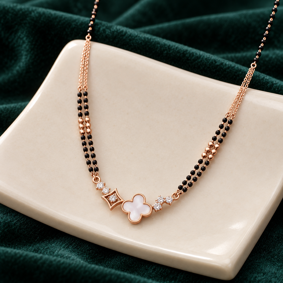 White clover mangalsutra arranged over cream sculptural ceramic