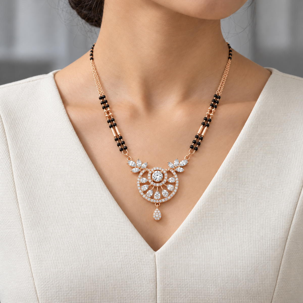 Celestia Mangalsutra worn with an ivory woven V-neck dress, showing the pendant and black bead chain.