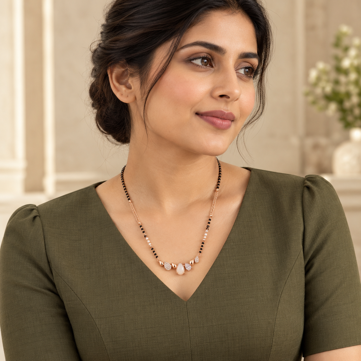 White pear-row mangalsutra styled with a tailored olive dress