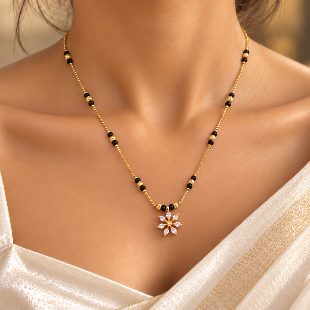Close-up of Kairavi Mangalsutra worn with an ivory saree, showing the seven-petal floral pendant