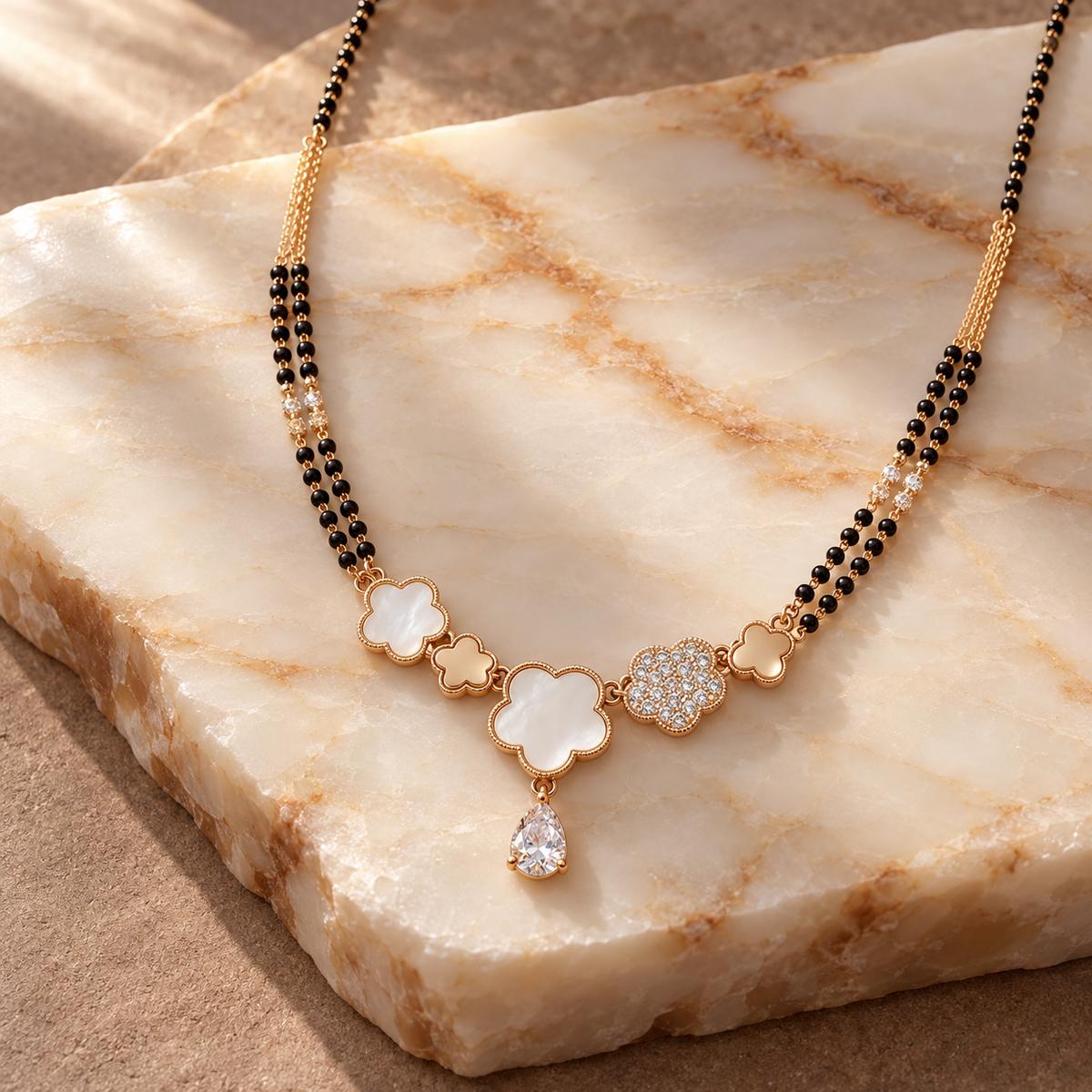 Liora double-strand clover mangalsutra on warm white onyx.