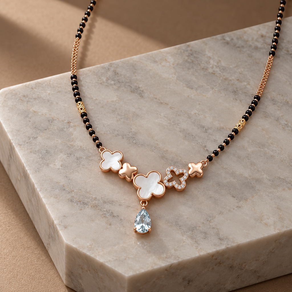 Maelle Mangalsutra — angled clover pendant view on pale grey marble