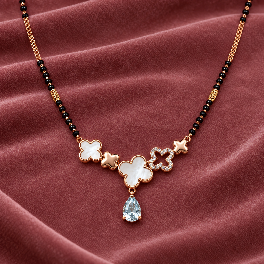 Maelle Mangalsutra — clover pendant detail on dusty-rose velvet