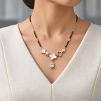 Maelle Mangalsutra worn with an ivory woven V-neck dress, showing the pendant and black bead chain.