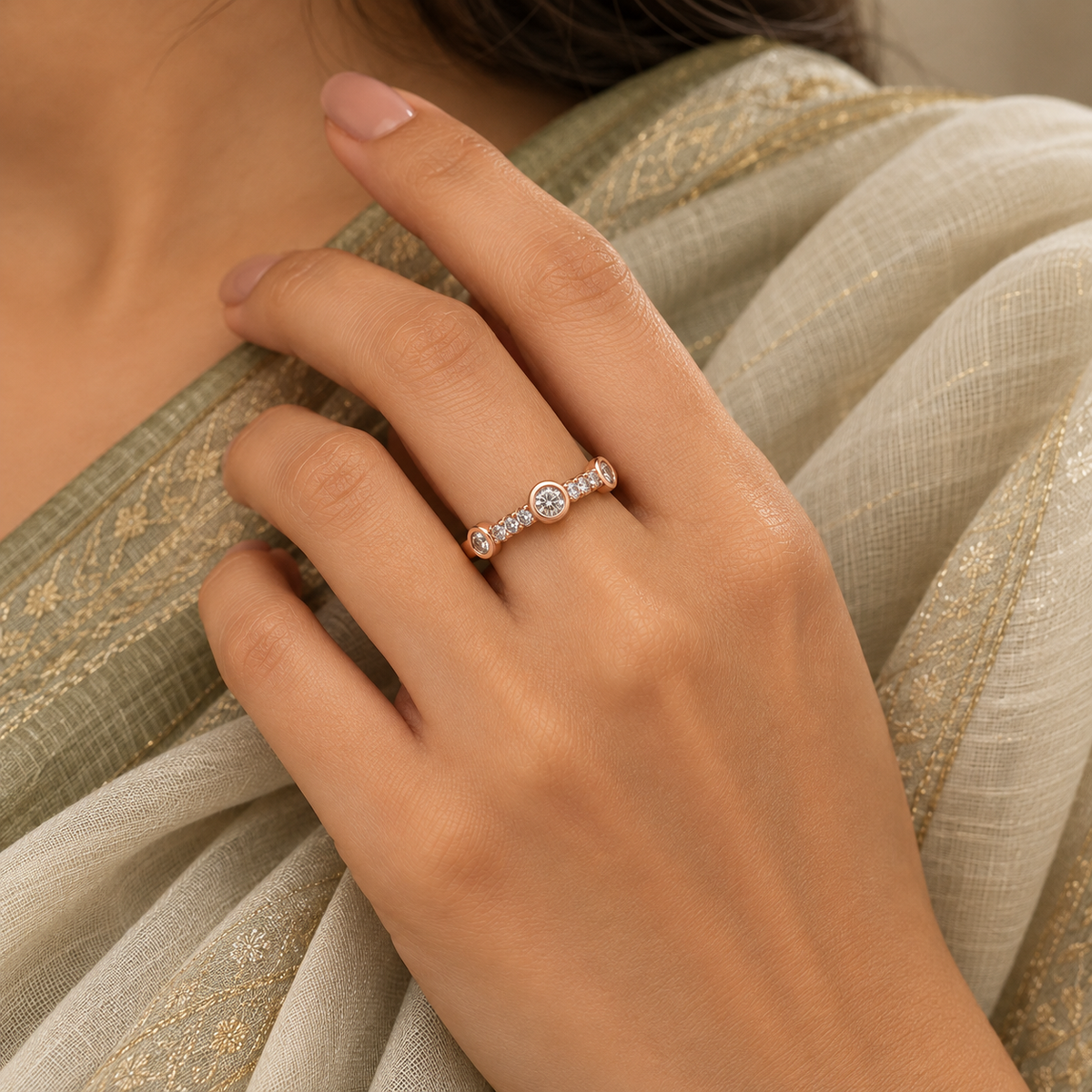 Trinity Ring rose gold plated ring worn snugly beside an ivory and sage saree