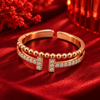 Vivienne Ring rose gold plated ring at a higher angle on crimson velvet with tonal red bokeh