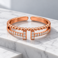 Vivienne Ring on a white marble architectural step