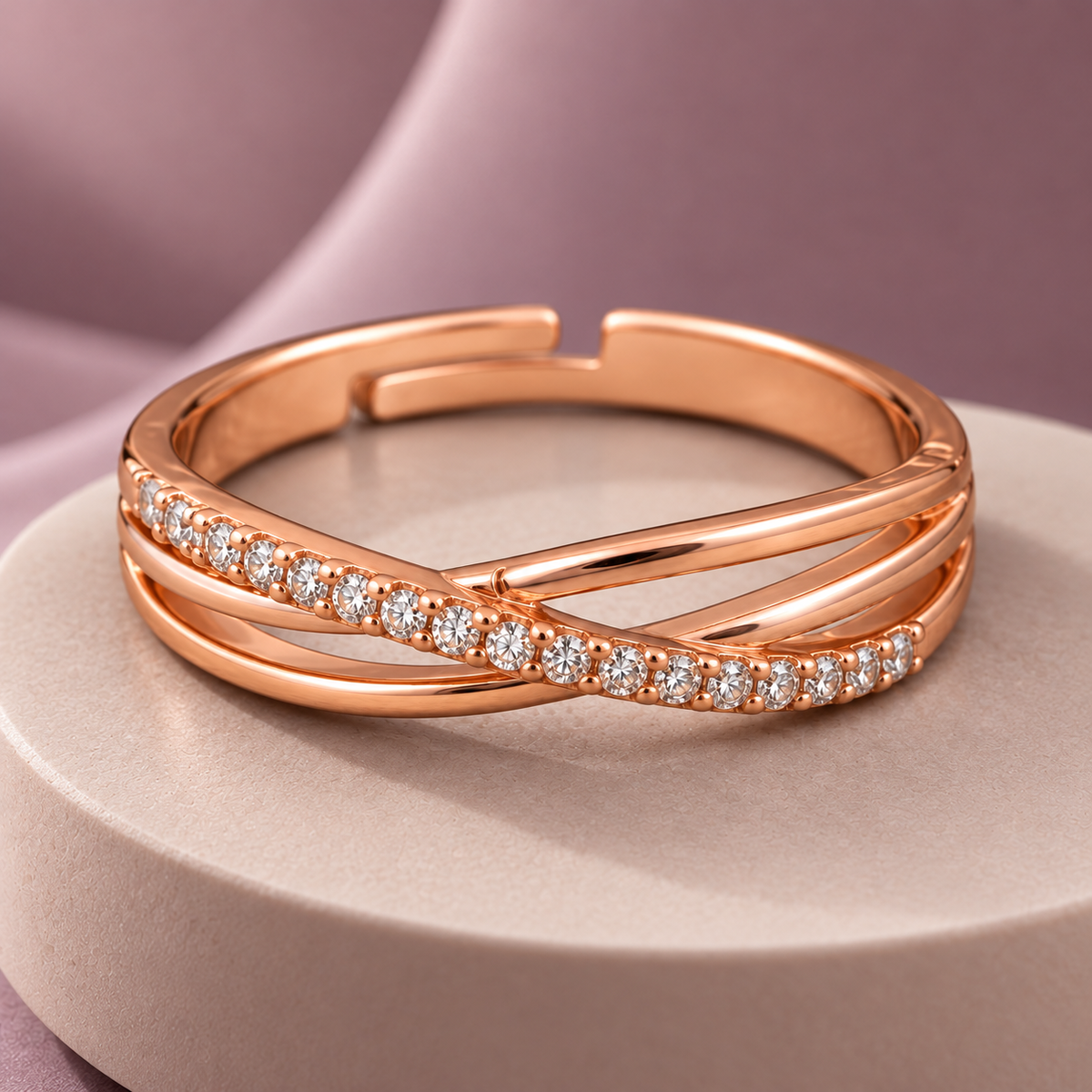 Aurelia Ring rose gold plated ring on a pale circular plinth with dusty mauve background