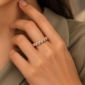Ophelia Ring in rose gold, worn snugly on a model's hand beside elegant tailored sage/taupe professional dress with modest covered chest