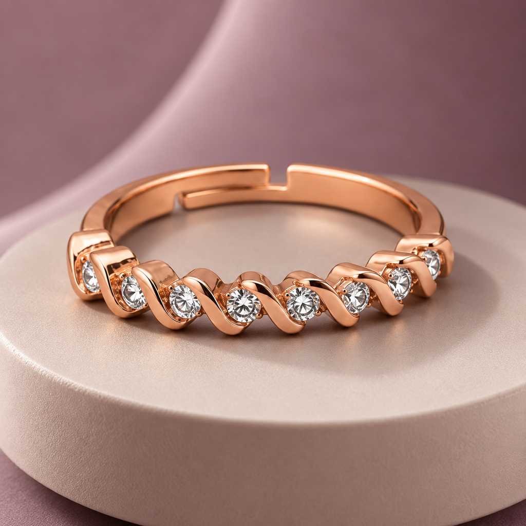 Ophelia Ring in rose gold, on a pale round plinth against a dusty mauve backdrop