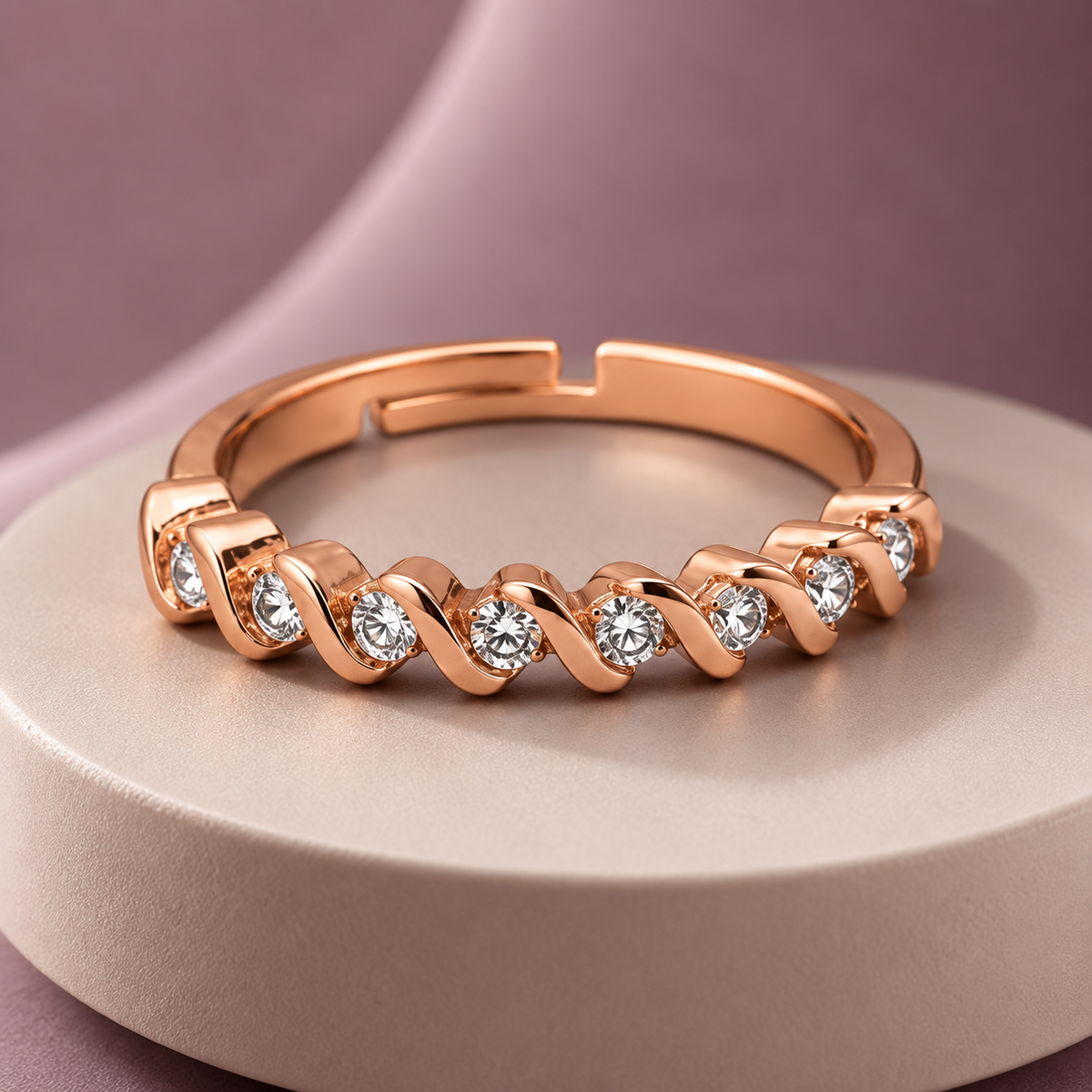 Ophelia Ring in rose gold, on a pale round plinth against a dusty mauve backdrop